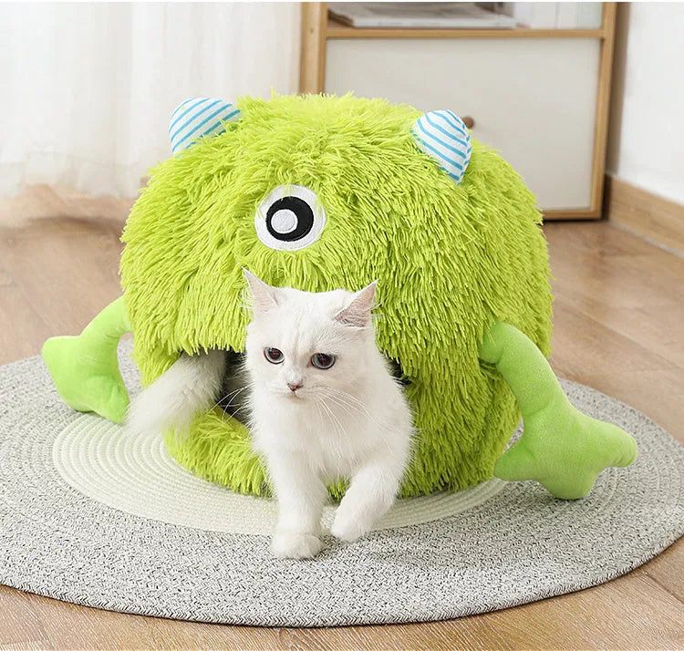 A round fluffy plush pet bed for cats and small dogs on a wooden floor.