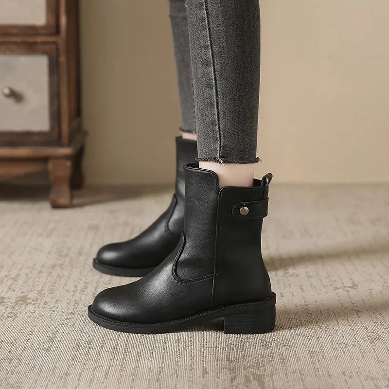 Black women's ankle boots with a round toe, side zip, and a low rubber sole.