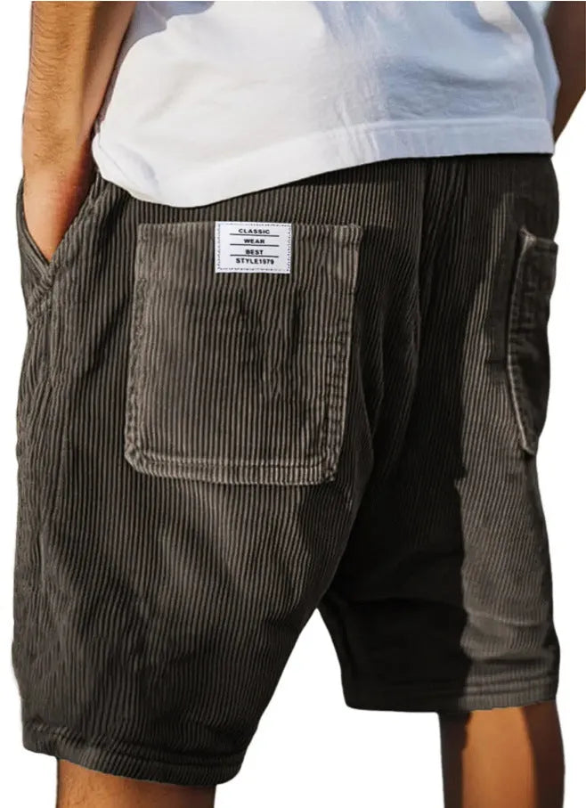 Men's grey corduroy shorts with multiple pockets and straight-leg cut on a neutral background.