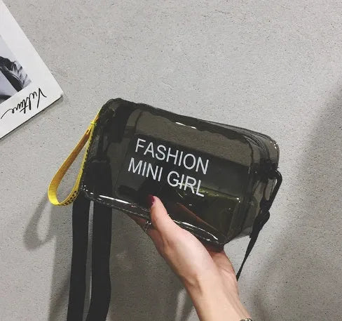 Transparent square women's shoulder bag in jelly material with a diagonal cross strap, showing internal mobile phone pocket.