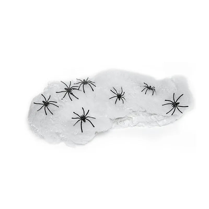 White cotton Halloween spider web decoration draped with plastic spider props.