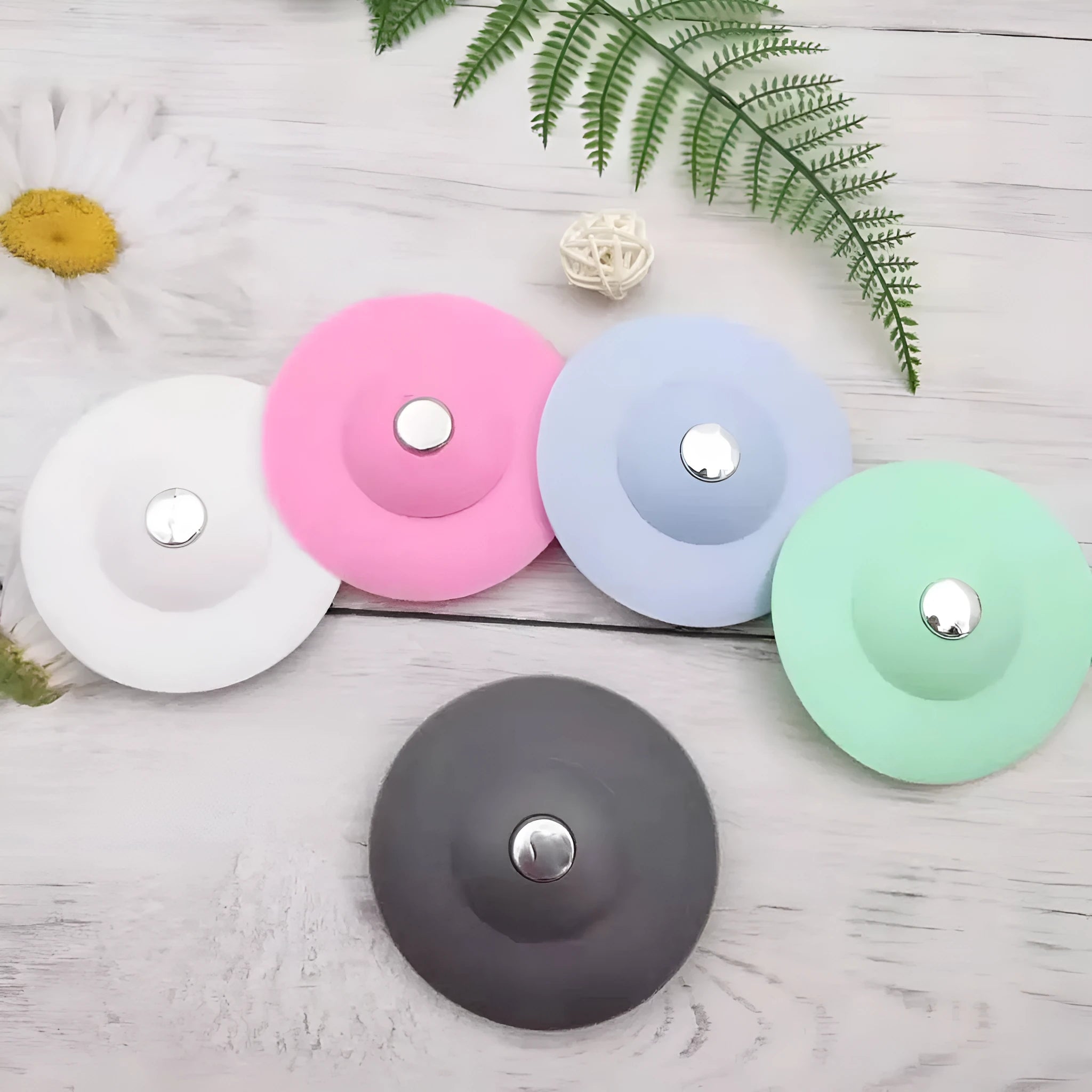 UFO-style silicone press sink drain cover in white on a modern kitchen sink