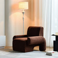 Nordic single sofa chair with solid wood frame and black off-white teddy fabric upholstery in a living room