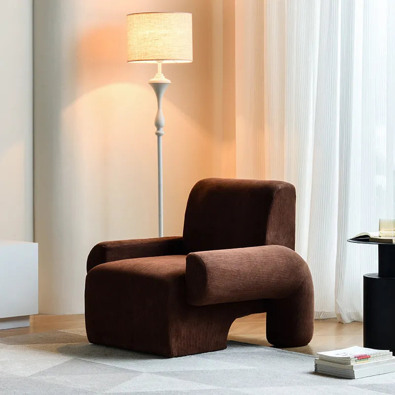 Nordic single sofa chair with solid wood frame and black off-white teddy fabric upholstery in a living room