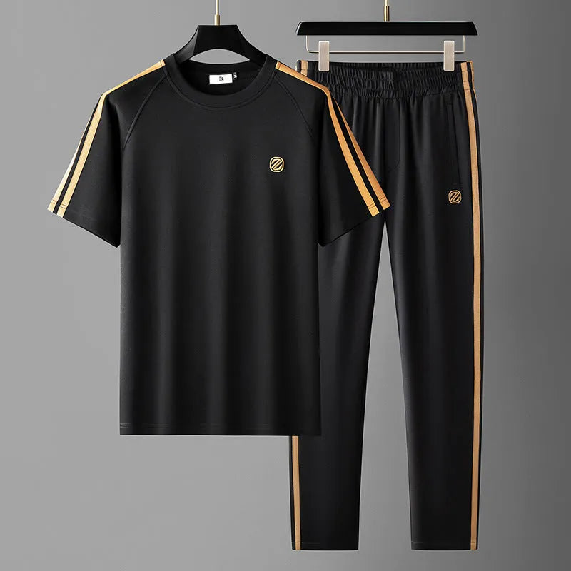 Men's blue short sleeve polyester suit set with matching top and trousers for sports activities