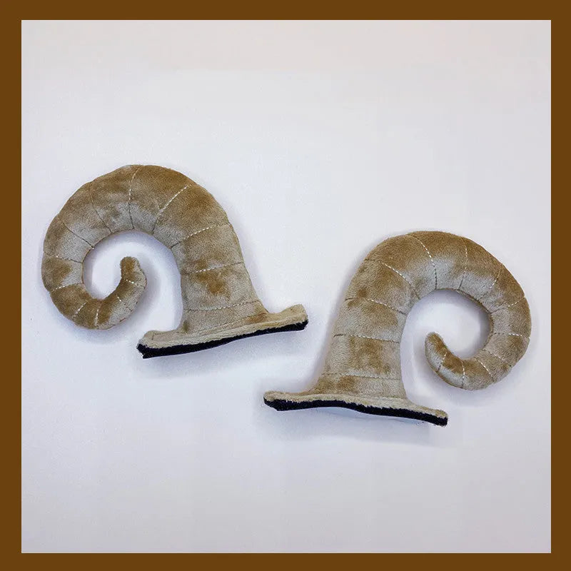 A pair of composite fibre demon bull horn ornaments for motorcycle helmet customisation.