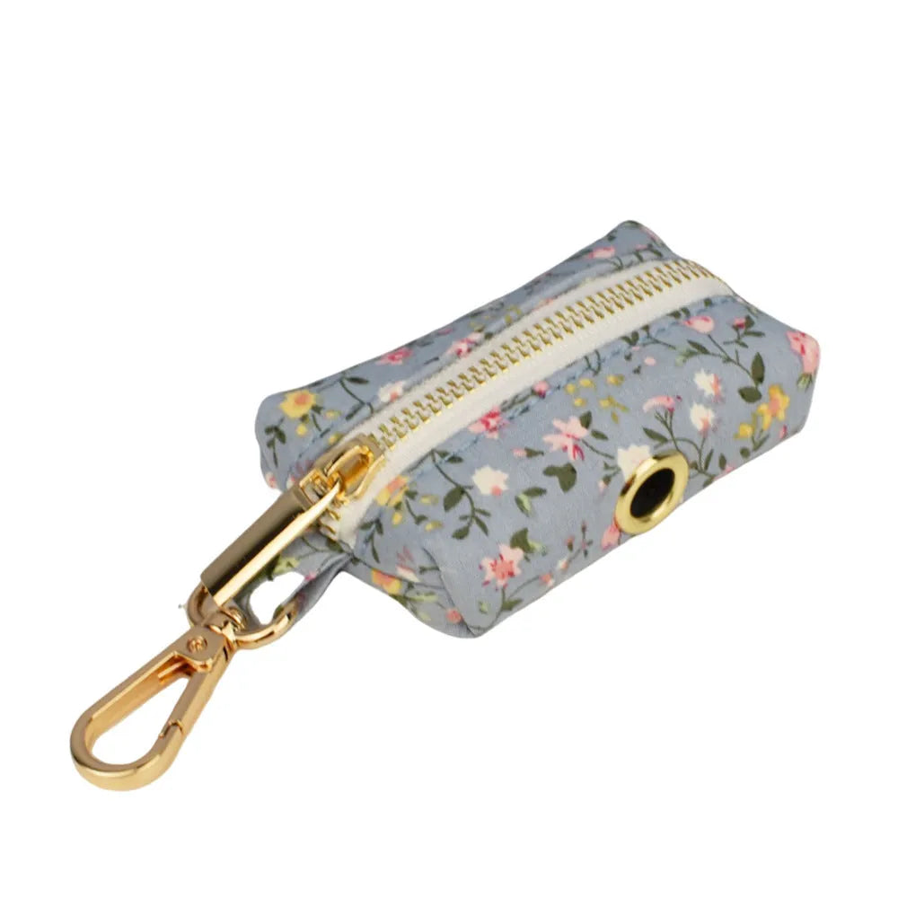 Blue floral pattern dog collar set with matching leash, bow, vest and waste bag dispenser accessories