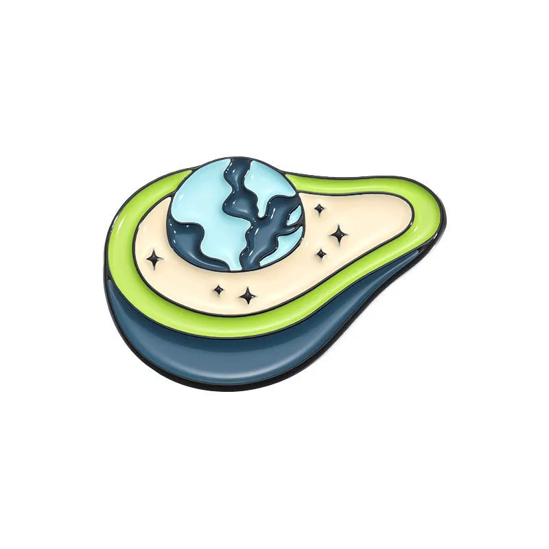 Colourful metal brooch with cartoon fruit and letter design on a blue background.