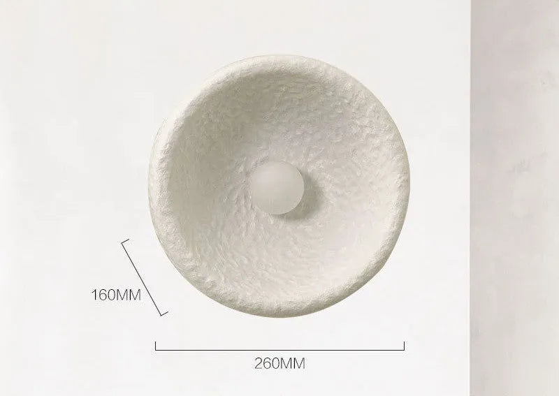 Japanese-style simple modern wall lamp with round resin shade in warm light
