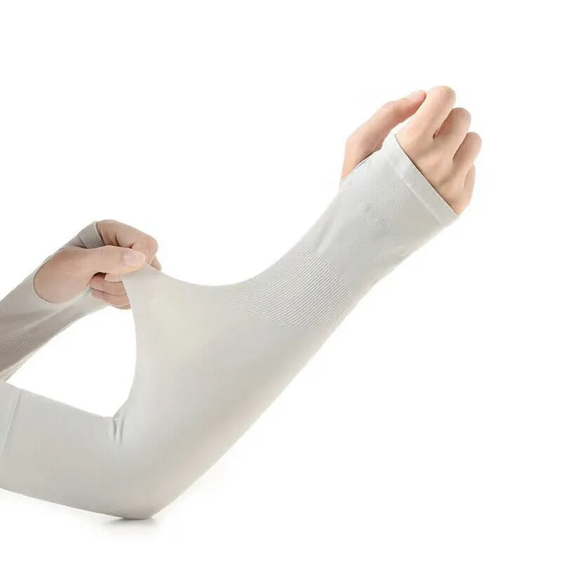 A person wearing a grey sun protection driving sleeve on their forearm, showing the open finger design.
