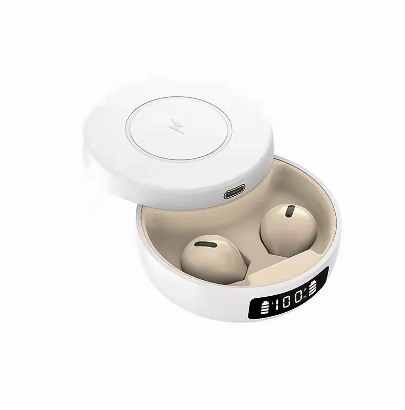 Small black semi-in-ear wireless headphones with their wireless charging case on a table.
