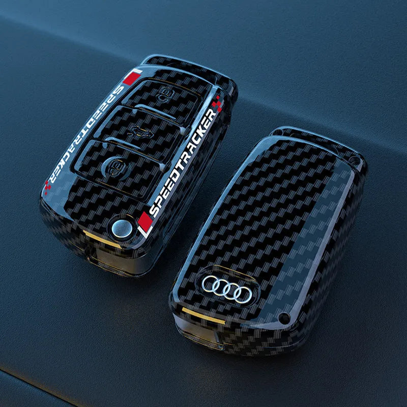 Car key cover with carbon fibre texture and mirrored detailing, white colour option shown alongside