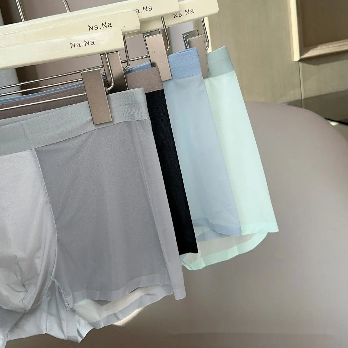 Ultra-thin seamless men's boxer shorts showing honeycomb crotch detail in ice silk fabric.