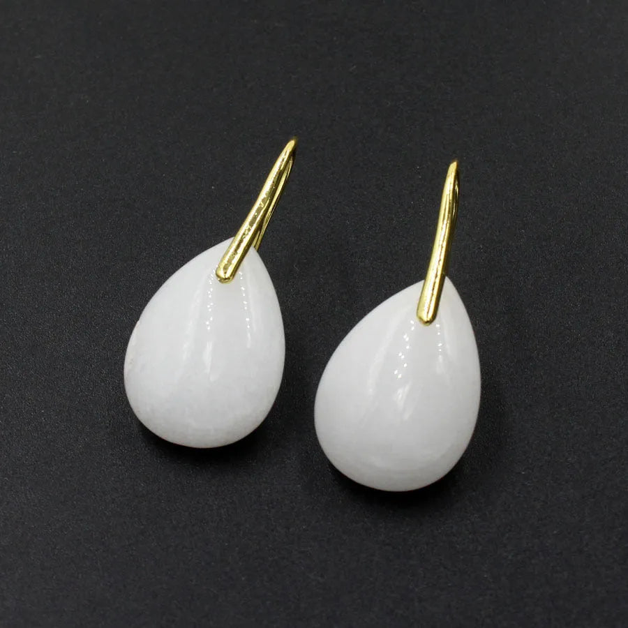 A pair of geometric water drop earrings made from crystal, shown in one of nine available colours like amethyst or obsidian.