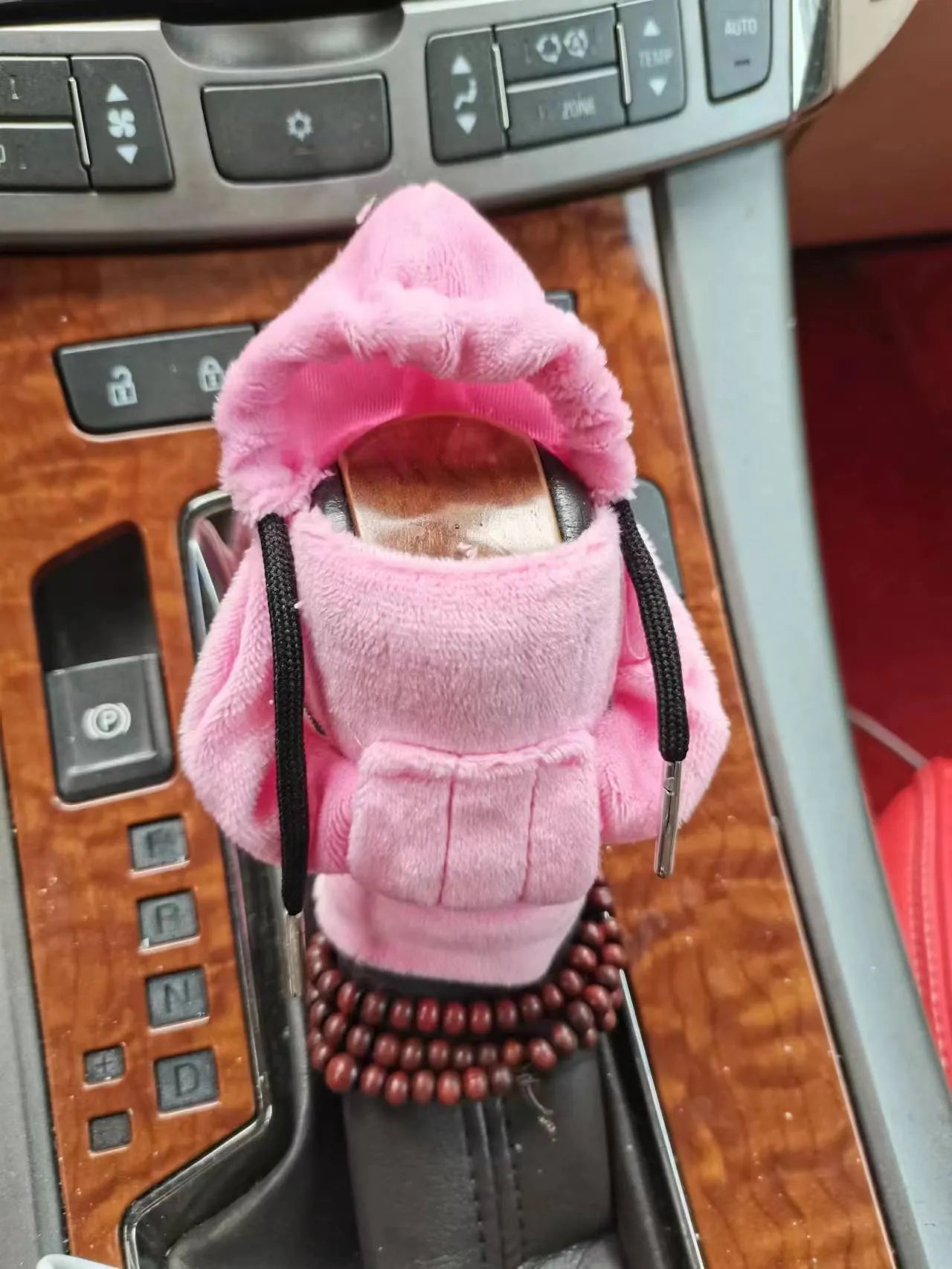 Dutch velvet car gear handle sleeve cover in multiple colours on a car gear lever.