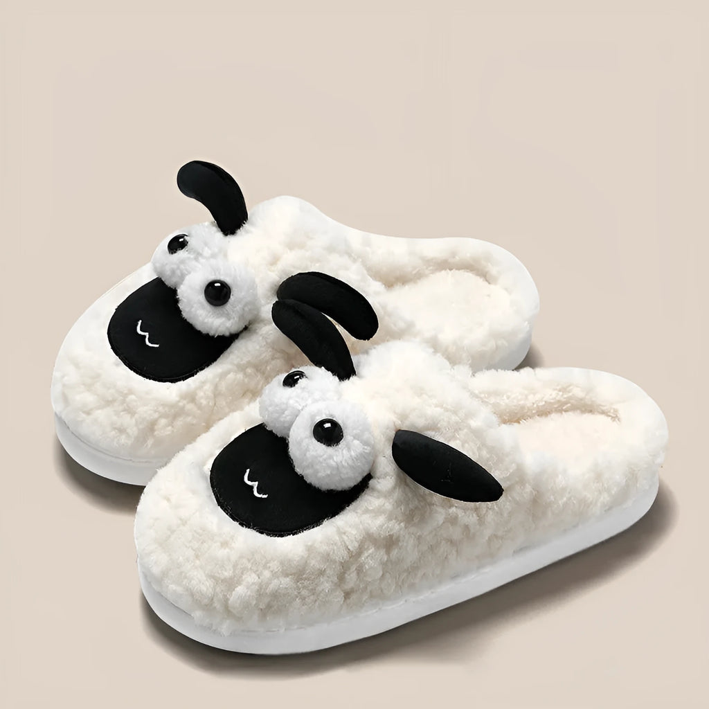 Brown thermal cotton slip-on slippers with suede upper and textured PVC sole on a wooden floor.
