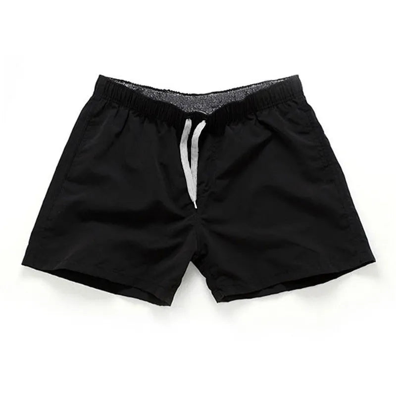 Men's straight-leg beach shorts in polyester, shown in a colour from the range including fluorescent yellow, black, or navy.