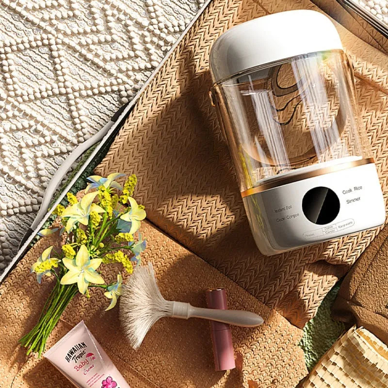 Smart electric stew cooker with transparent glass inner pot and fibre glass body, showing power cord and compact size