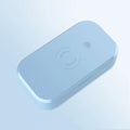 White ultraviolet disinfection box with wireless charging pad for mobile phones and nail tools.
