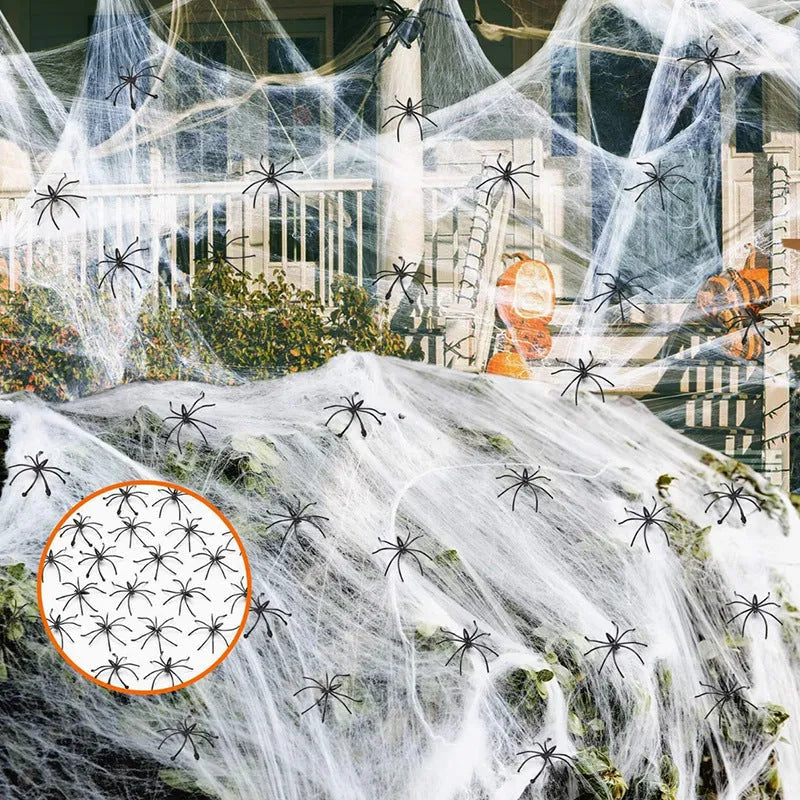 White cotton Halloween spider web decoration draped with plastic spider props.