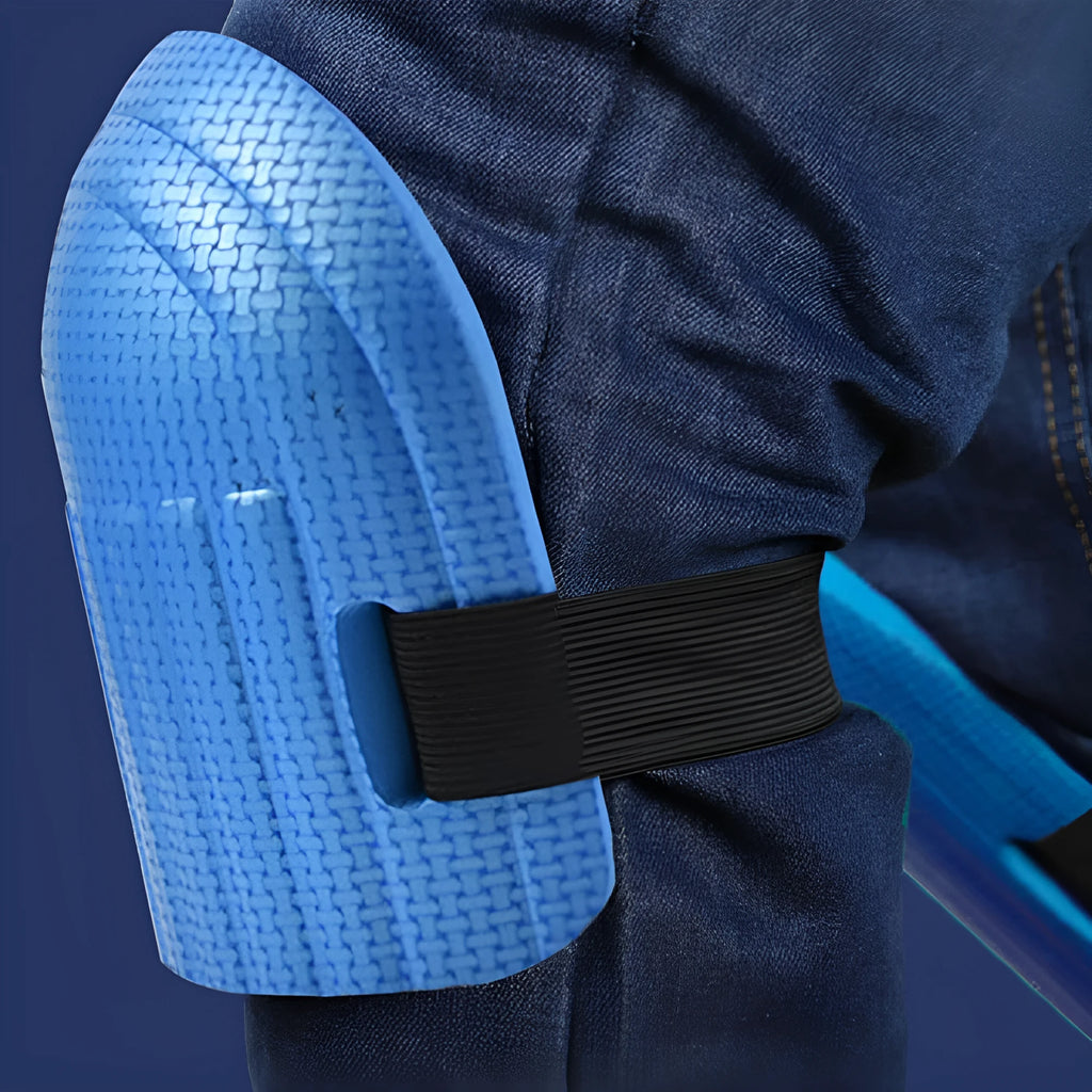 A pair of EVA foam kneepads in black, shown on a hard floor surface.