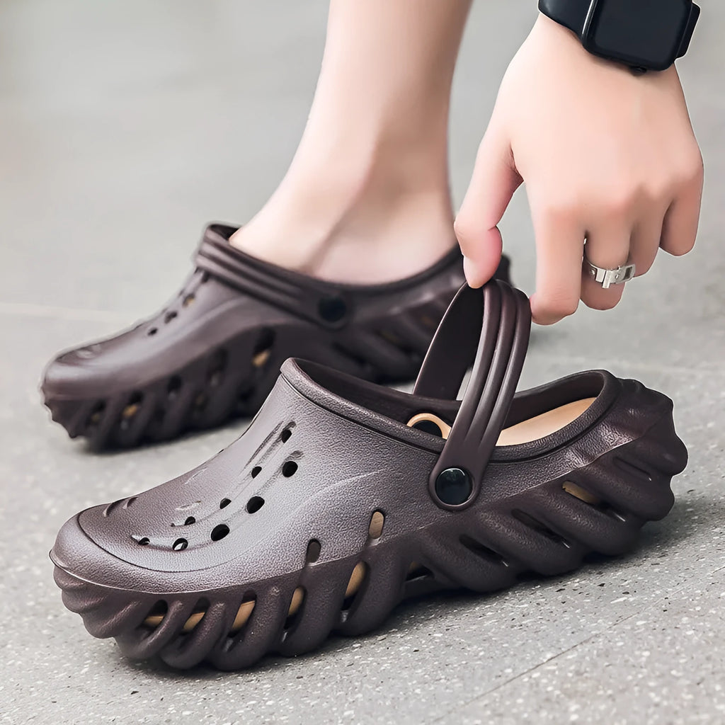 Men's beige EVA slipper sandals with hollow-out design and non-slip sole, shown from the side.