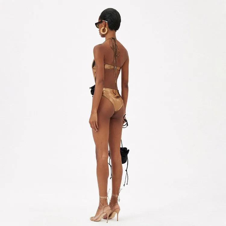 Gold handmade halter neck one-piece swimsuit with hollow-out design on mannequin
