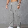 Men's straight-leg corduroy cargo trousers in brick red with a drawstring waist
