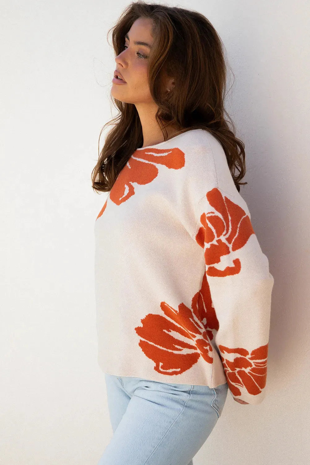 Beige bold flower pattern wide sleeve baggy sweater on display showing loose fit and floral print