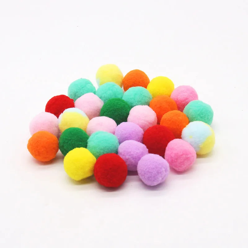 Pet toy launcher gun and soft plush balls for interactive play with cats and dogs.