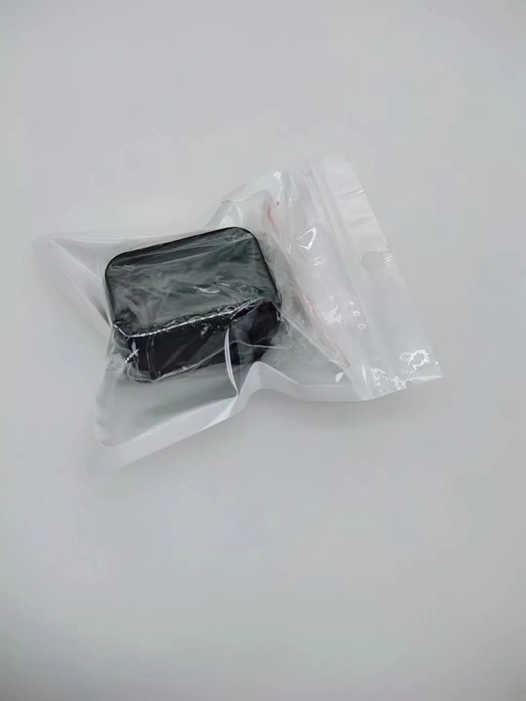 Black ABS plastic seat belt lock clamp holder securing car seat belt buckle