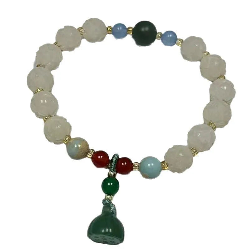 Carved pumpkin and lotus bead bracelet made from Bodhi root with white jade and aventurine details.