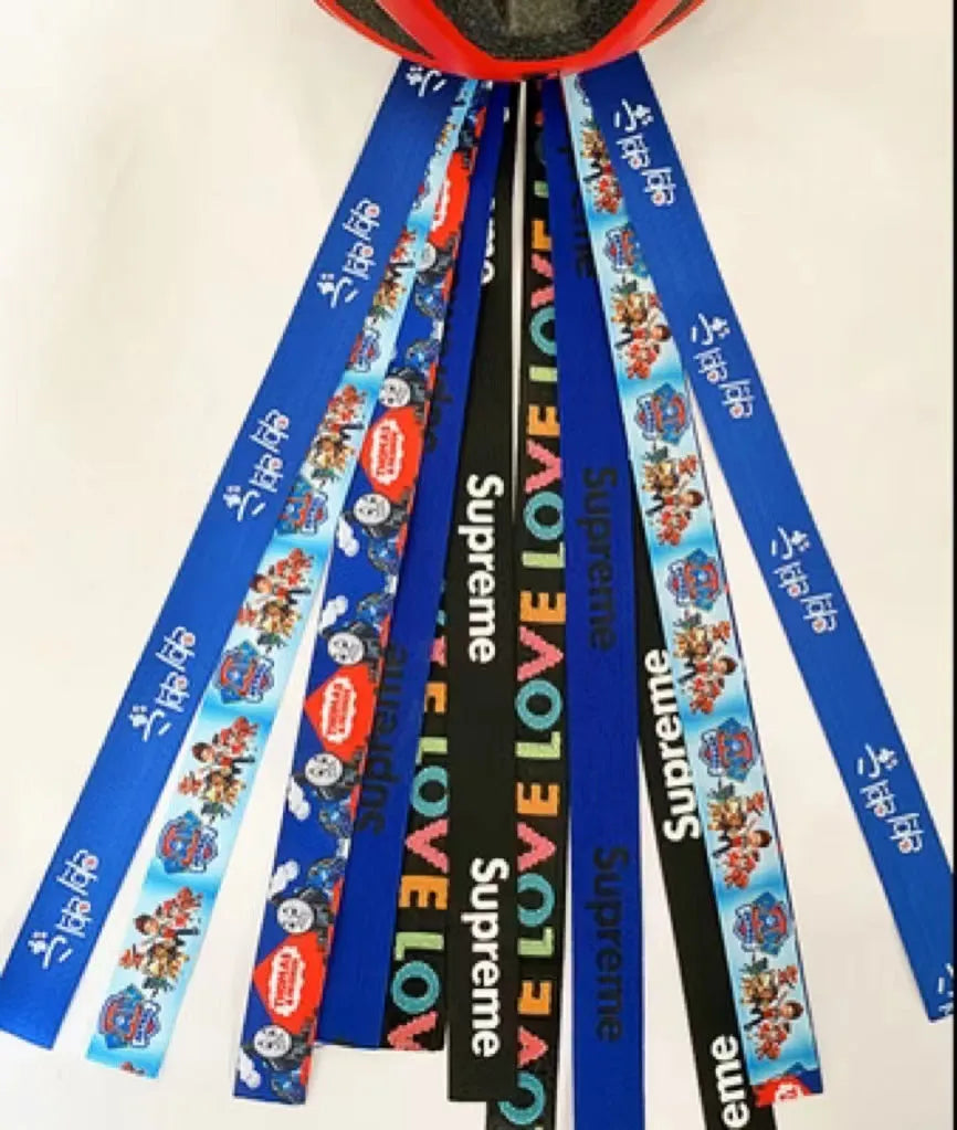 Colourful decorative ribbon streamers attached to a children safety helmet for skating or skiing