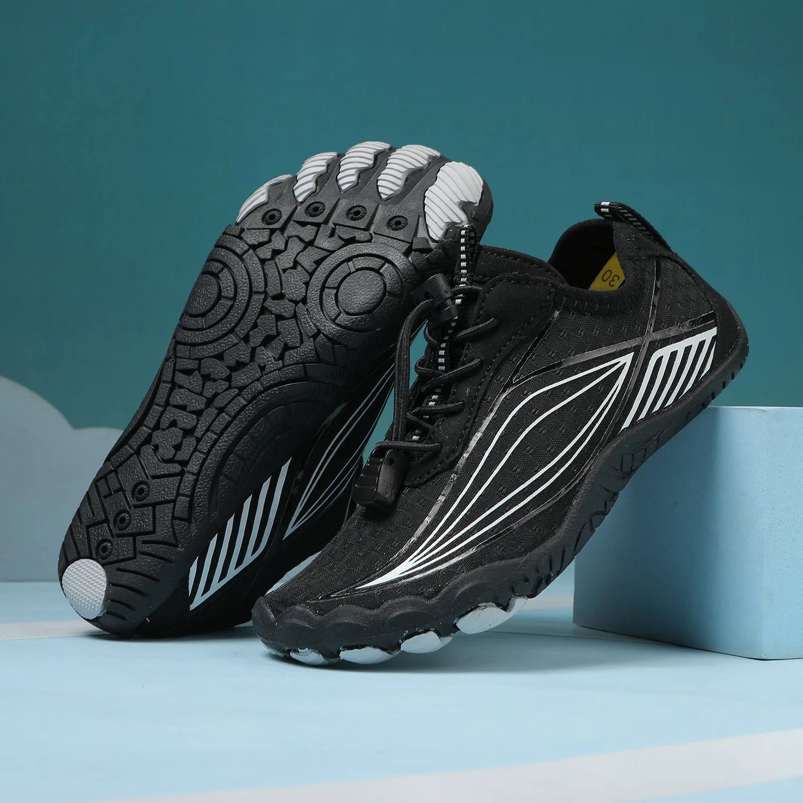 Children's black quick-drying water shoes with a non-slip rubber sole and elastic band.