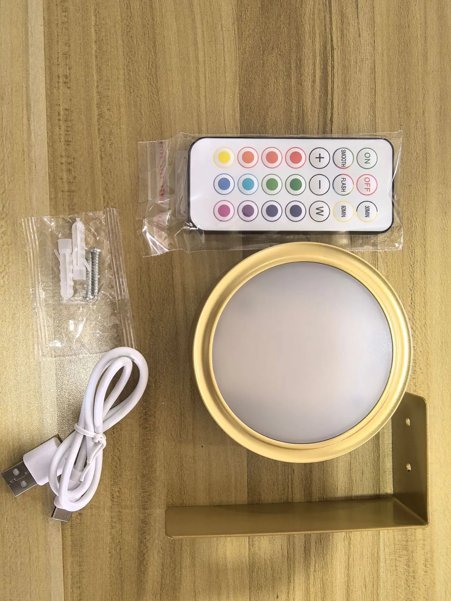 Wireless rechargeable LED painting lamp with magnetic belt attached to a metal frame, remote control nearby.