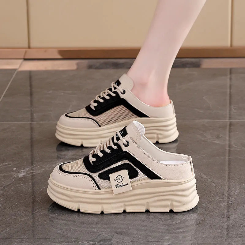 Women's black mesh half slipper with round toe and rubber sole on a white background.