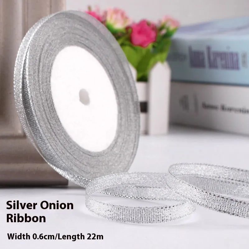 Roll of 0.6cm wide polyester gift ribbon in various colours including gold leaf, coffee and sky blue options