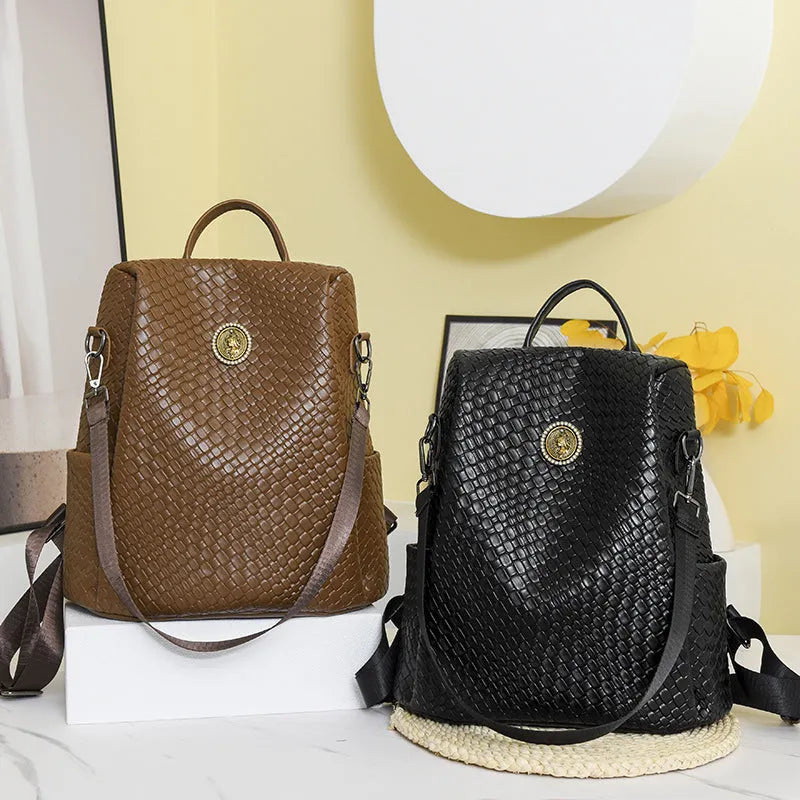 Women's black anti-theft backpack with multiple compartments and woven design details