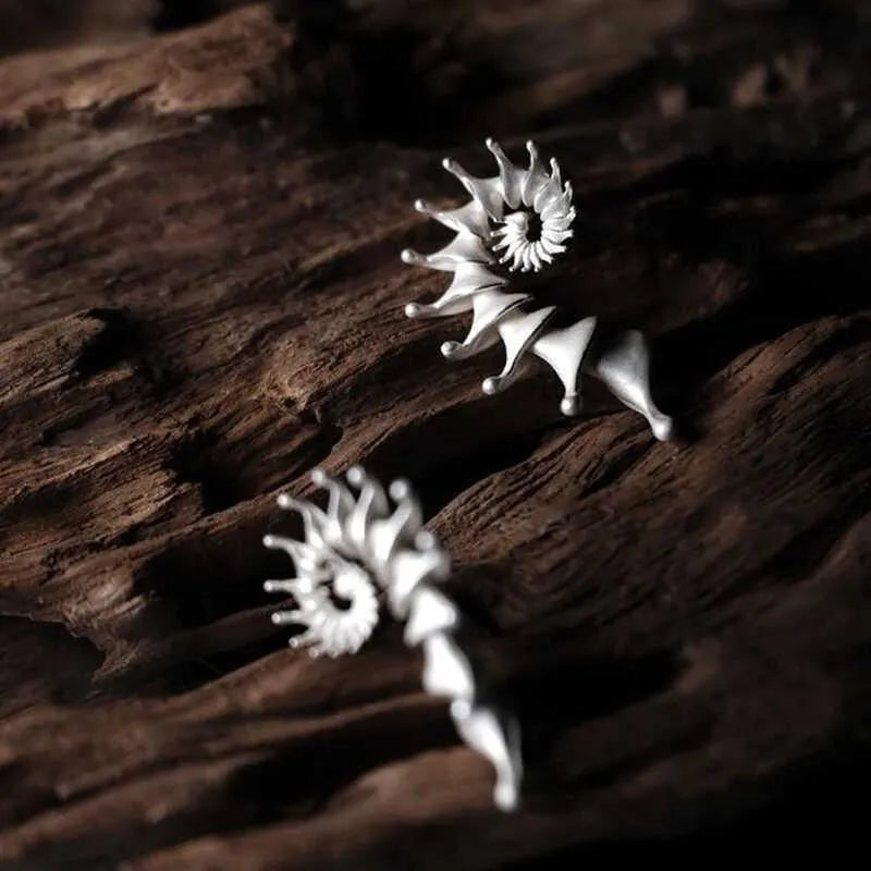 Exaggerated three-dimensional matte conch stud earrings in an alloy with an electroplated finish.