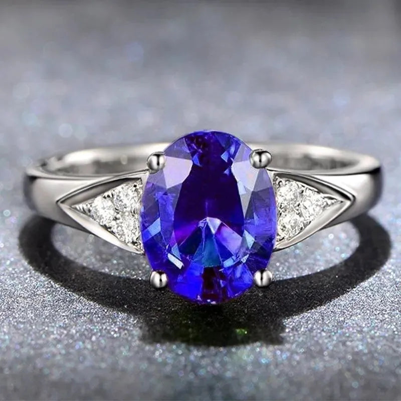 Women's blue zircon court style ring with heart, water drop, and bell pattern designs.