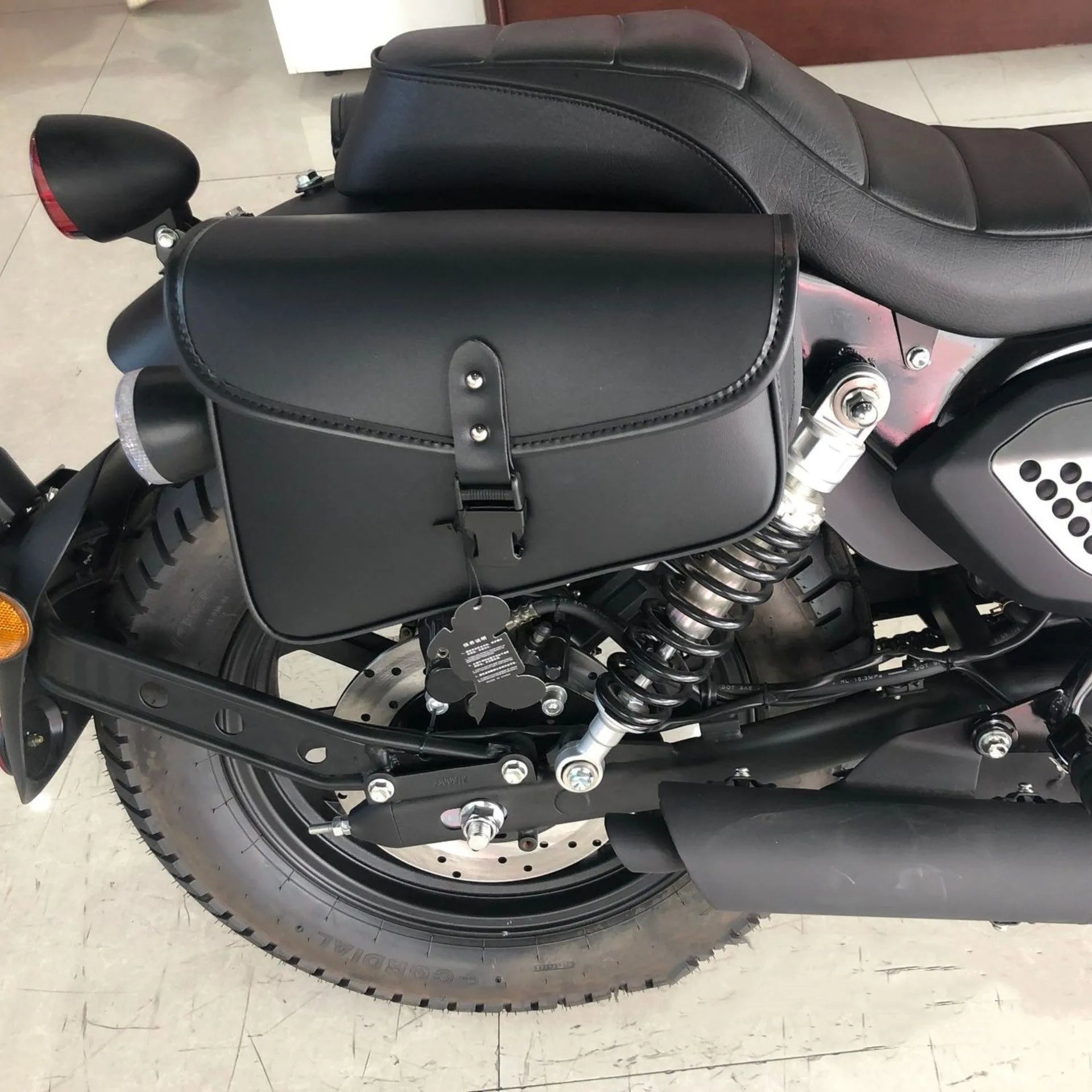 Black PU leather swingarm saddlebag mounted on a Harley Davidson Sportster motorcycle.