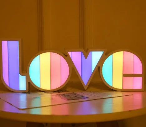 Colourful LED love light decorative lamp with plastic shell on a table