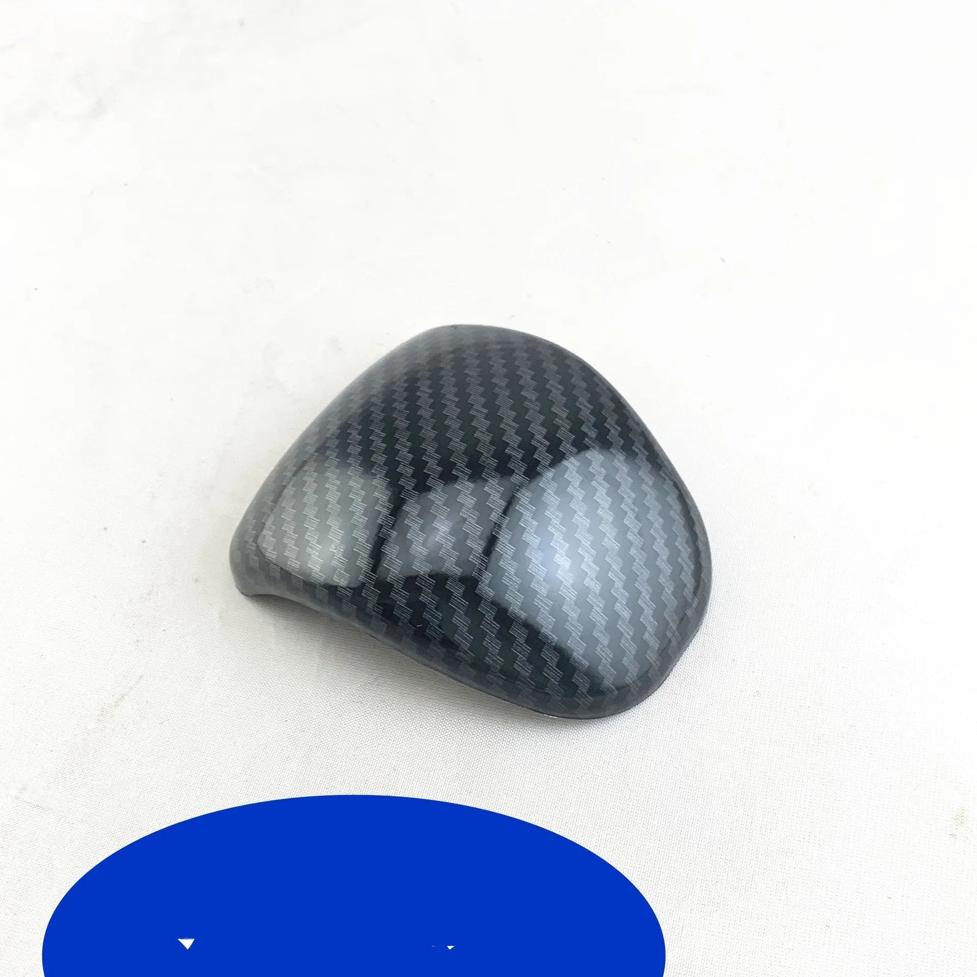 Black carbon fibre pattern gear shift cover for car interior with textured anti-slip surface
