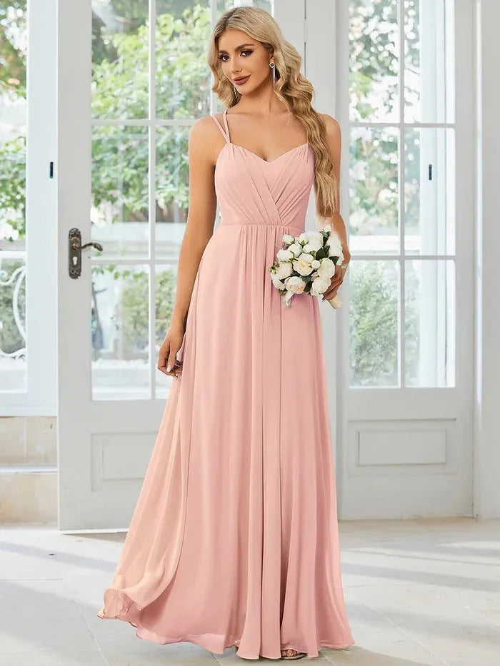Women's sleeveless pleated A-line dress in light green with sling neckline for banquet occasions