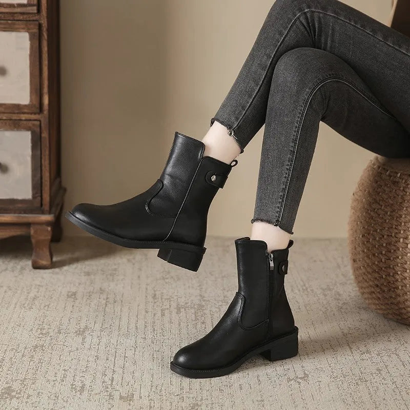 Black women's ankle boots with a round toe, side zip, and a low rubber sole.