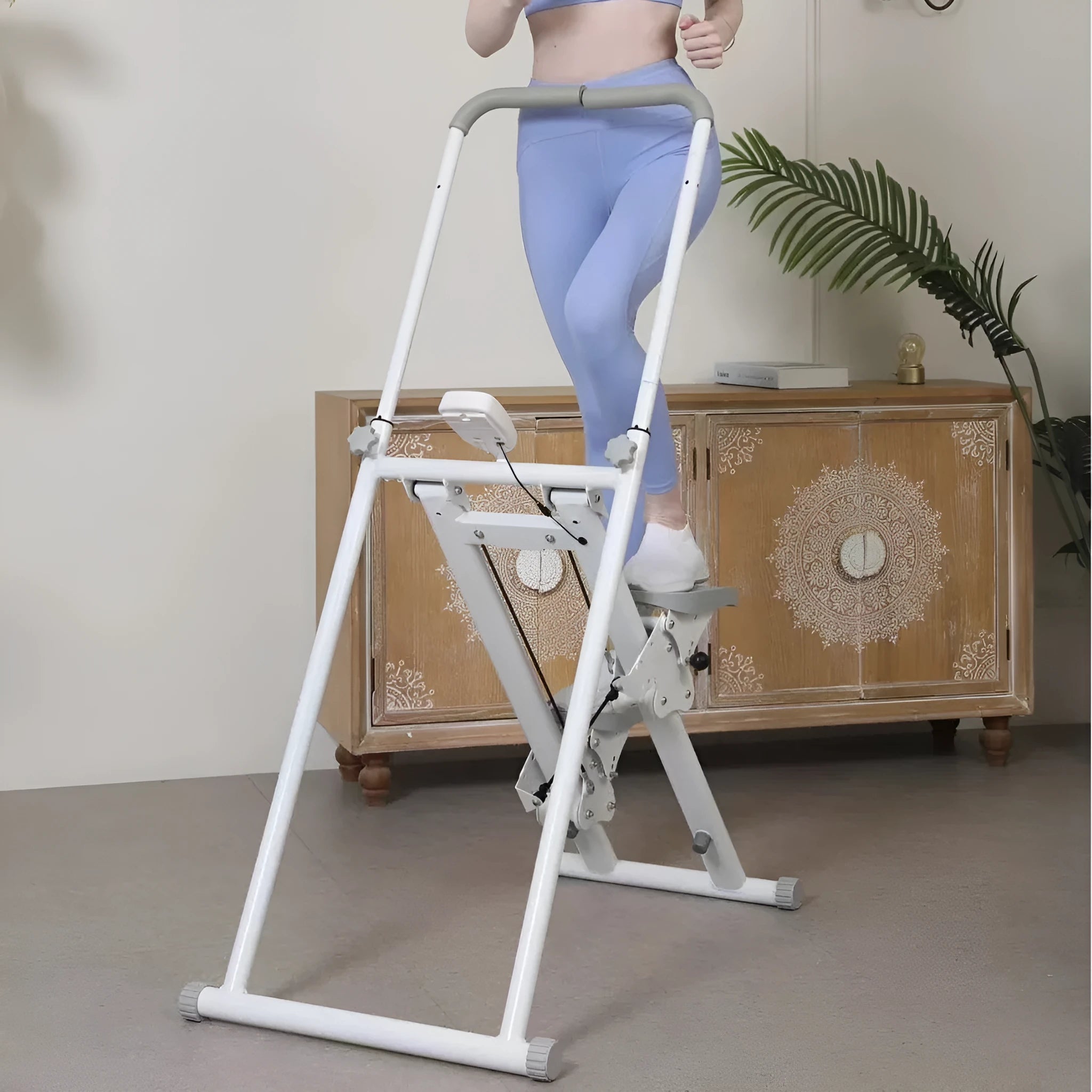 White folding treadmill with integrated climbing frame for home fitness workouts