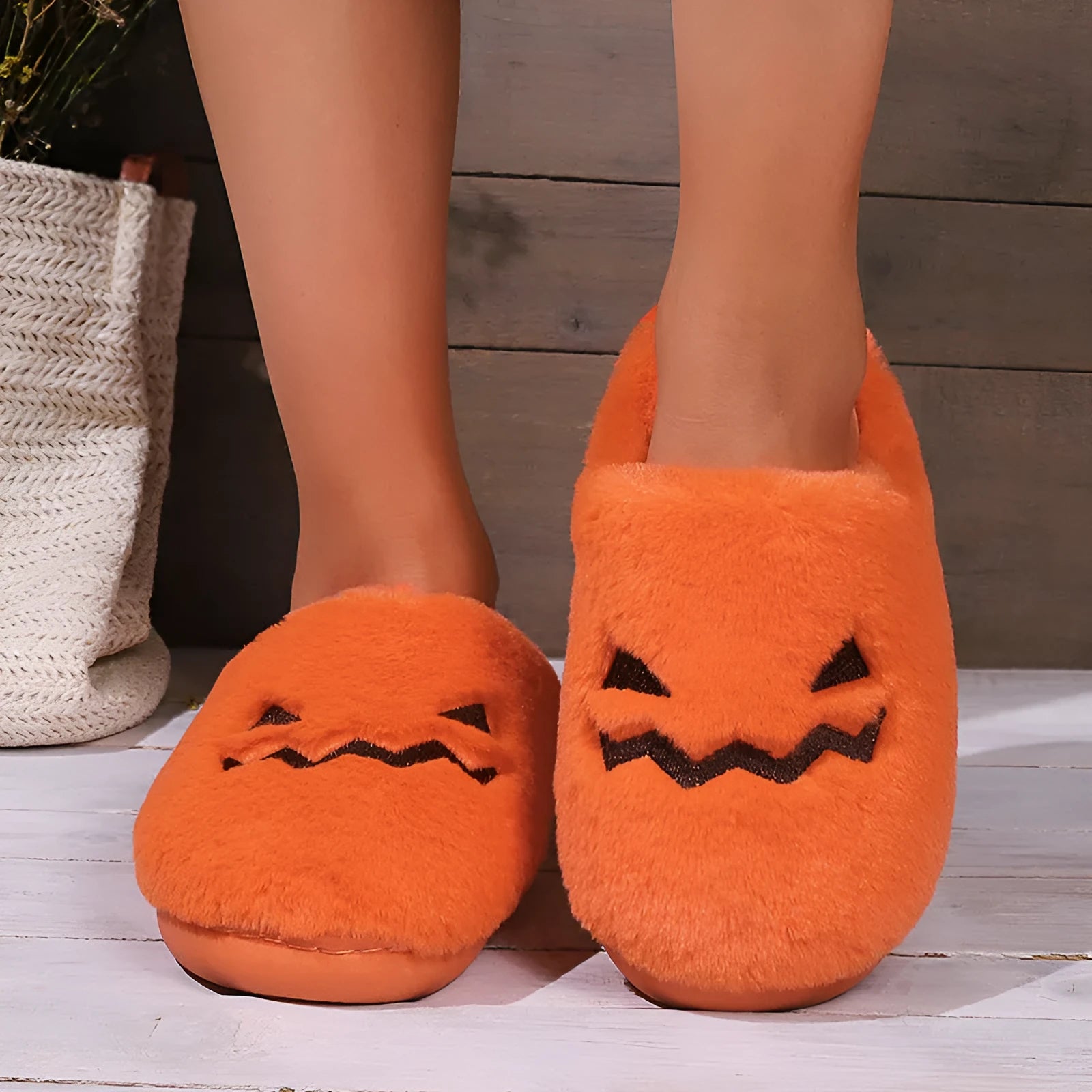 Orange coral velvet Halloween pumpkin slippers with plush lining and a grey non-slip PVC sole.