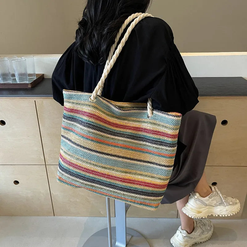 Blue straw woven large capacity single-shoulder bag with nylon construction.