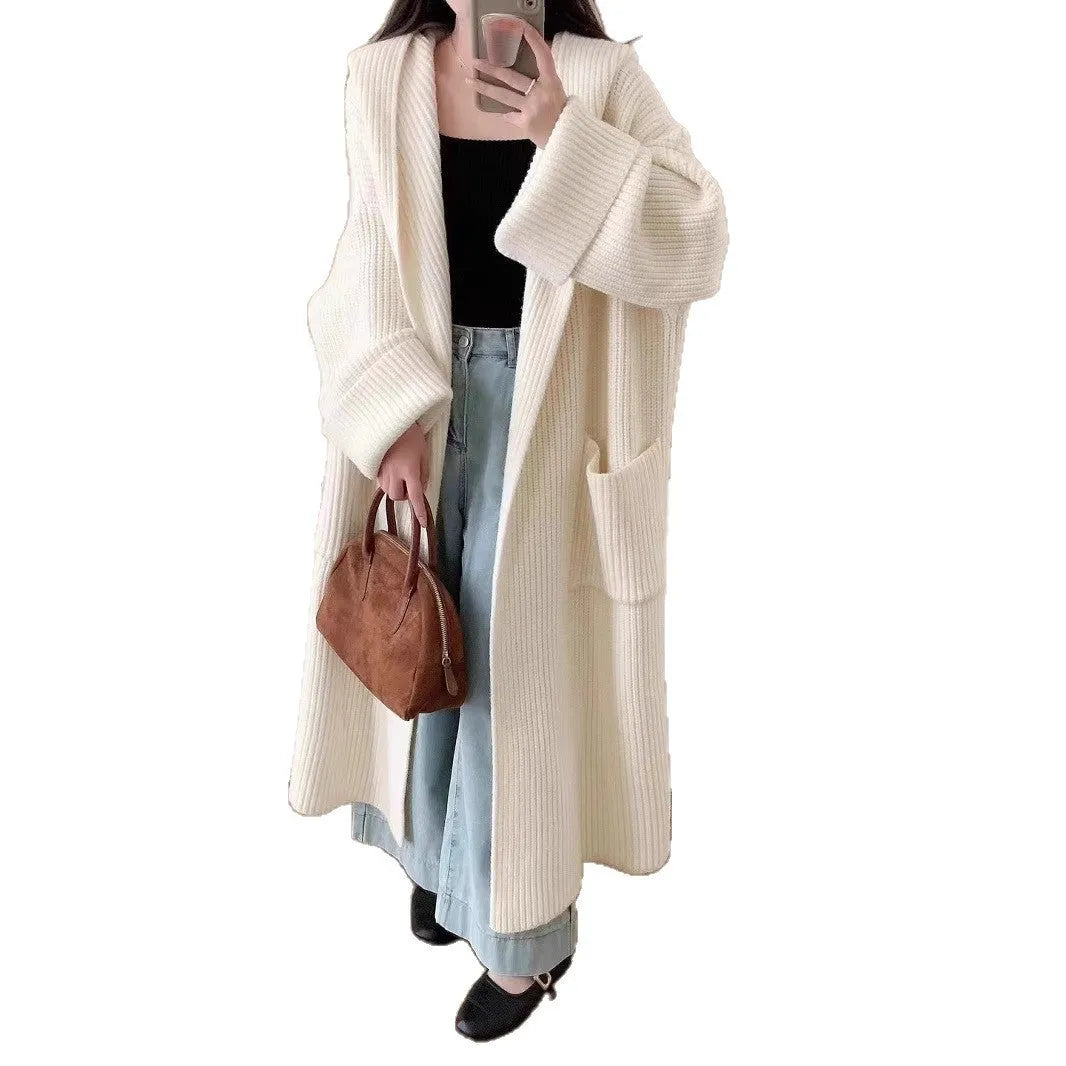 Women's loose grey hooded cardigan coat with raglan sleeves on a hanger
