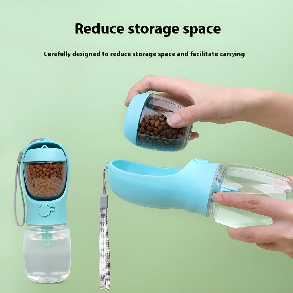 A blue portable plastic dog water bottle with an integrated flip-out drinking bowl on a green background.